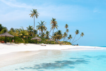 Obraz premium Vacation summer holidays leisure background - sunny tropical Caribbean paradise resort beach with white sand, lounger, palms on Maldive
