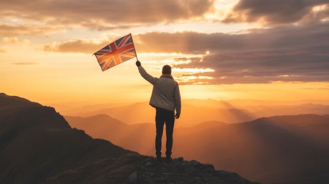 Upholding the Union: A silhouette stands atop a mountain peak, proudly waving the Union Jack flag against the backdrop of a breathtaking sunset, symbolizing national pride and triumph.