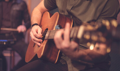Close-up of Creative Artist Playing Acoustic Guitar During Rehearsal