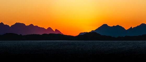 Fototapeta premium Sunset over Henningsvær – Golden Hour and Colorful Sky in Lofoten