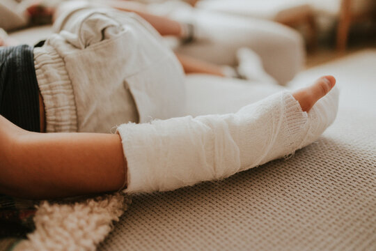 Child with bandaged injury receiving treatment and care