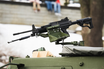 Modern automatic machine gun mounted on a military armored vehicle turret during a public outdoor event in a city © Dmitri