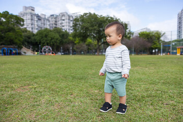 Baby running on the grass outdoors