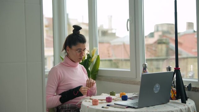 Quiet seamstress engaged in soothing needlework as daylight filters in