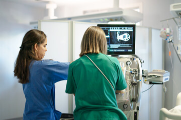 Medical staff collaborating with advanced dialysis equipment