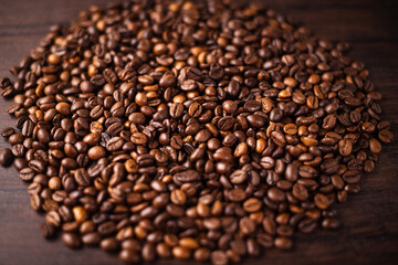Fototapeta premium Coffee beans and cappuccino in red cup on wooden background, closeup shot. cafe style, aroma, fresh morning, hot beverage, rustic feel 