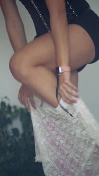 Sultry model showcasing neon stockings and lace skirt in studio