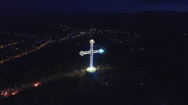 Cinematic Orbit Drone Shot of Illuminated Meskel Cross on Kemdaero Mountain at Night, Adigrat, Ethiopia