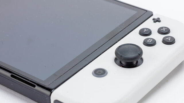 close up of a Nintendo Switch console with controller attached.