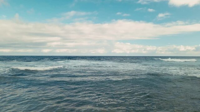Wave Crashes Shore. Vivid Ocean Swell Collides With Tranquil Sandy Shoreline Beneath Cloudy Sky