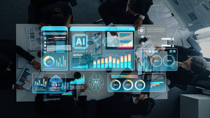Fototapeta premium A professional team collaborates in a modern office environment, utilizing advanced AI technology to analyze data and visualize business statistics for informed decision-making. Trope