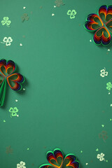 Obraz premium St. Patrick's Day frame made of rainbow paper shamrocks with central copy space. Creative border design on green background for festive Irish greetings and text.