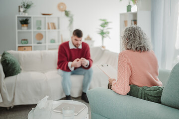 Fototapeta premium Man discussing problems with therapist during counseling session