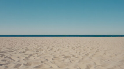 empty sandy beach with clear blue sky and ocean