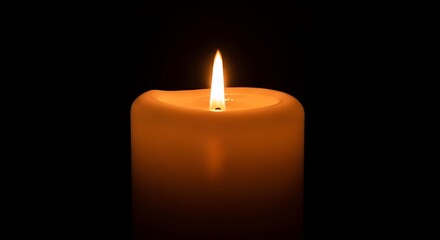 Close-up of a lit candle, flame burning brightly against a black background