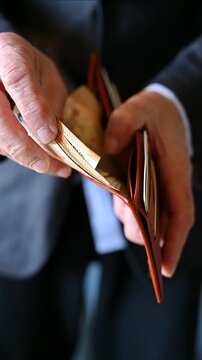 businessman hands opening leather wallet with euro bills, cash, wealth, and personal finance concept, Vertical business video
