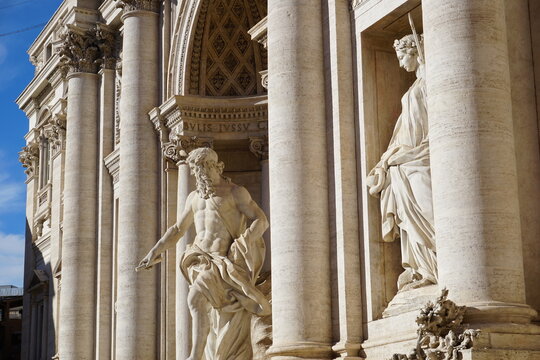 Side profile of historic statues between the monumental columns of Trevi Fountain (Fontana di Trevi), a Baroque landmark of Rome, Italy