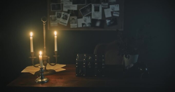 Cinematic dolly in on small lock box on table with spooky lighting and candles on table