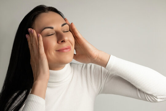 Peaceful Woman Enjoying Relaxation With Eyes Closed