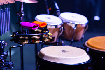 Fototapeta premium Percussion Setup with Meinl Cowbells, Tambourine, and LP Congas on Stage