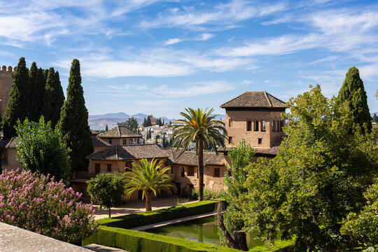 Granada, Spain August 19, 2025. Beautiful view of the Alhambra, Partal Palace and garden with water pool , complex located in Granada, Spain,  summer day. Andalusia.