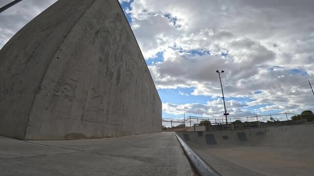 BMX rider downside footplant on a quarterpipe wall