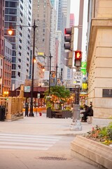 Fototapeta premium View of a person walking down the street with Chicago Buildings in the background at Sunrise