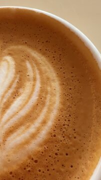 Gentle ripples and soft sunlight highlight coffee artistry