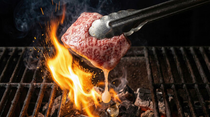 Dripping wagyu beef fat hitting hot coals causing sudden fire flare
