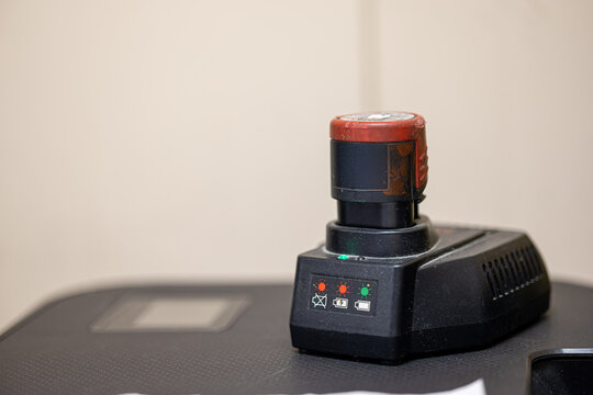 Lithium ion battery pack charging on professional charger station for cordless power tools