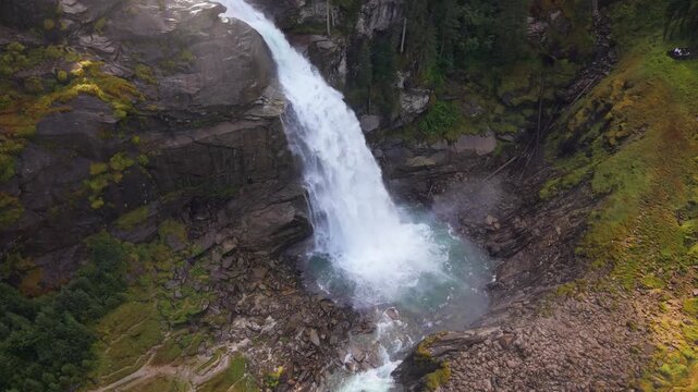 Breathtaking 4K aerial of the mighty Krimml Waterfalls in Austria. Experience the raw power of Europe's highest cascades as glacial water crashes through the majestic Hohe Tauern Alps
