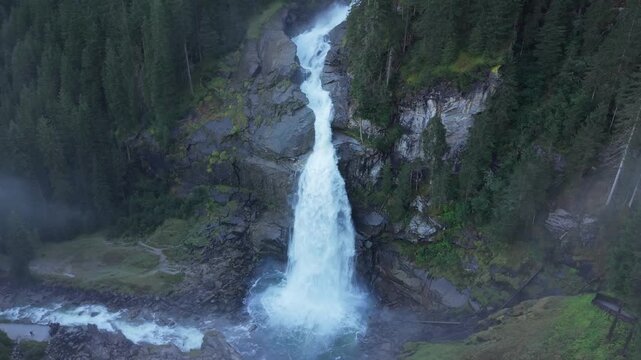 Breathtaking 4K aerial of the mighty Krimml Waterfalls in Austria. Experience the raw power of Europe's highest cascades as glacial water crashes through the majestic Hohe Tauern Alps