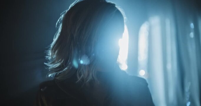 Closeup of young woman walking through dark, foggy, spooky room then opening small chest and accidentally  tipping it over