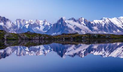 Fototapeta premium Mont Blanc, the highest peak in the Alps, rises elegantly above the alpine landscape near Chamonix on the border of France and Italy. At 4,808 meters, Mont Blanc is one of Europe’s most iconic natural