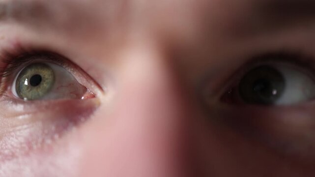 Closeup shows detailed view of two human eyes revealing natural texture subtle veins and realistic iris patterns creating a neutral macro shot useful for medical or cosmetic themes