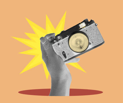 hand holding a film camera with flash