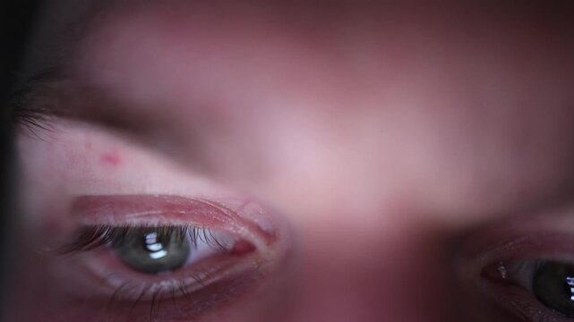 People are spending more and more time stuck in their phones close up of eyes illuminated by smartphone screen endless scrolling through social media and growing digital addiction