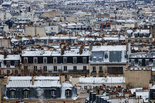 Aerial view of snow-covered rooftops in winter Paris, France