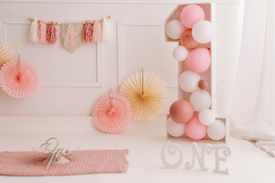 First birthday party backdrop with pastel balloons and number one decoration