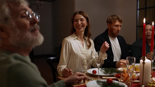 A man and woman and a female guest listen to a grandfather talking while they sit at a table
