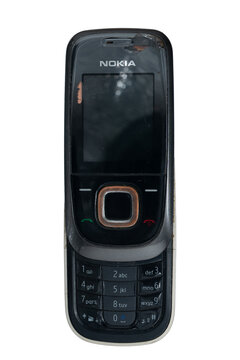 Madrid, spain 20 february 2026. Old worn nokia mobile phone isolated on a white background showing vintage technology
