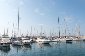 Sailing yachts moored in marina under clear blue sky