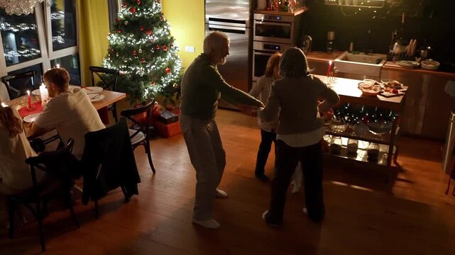 Grandparents dancing with their grandson and granddaughter while holding hands