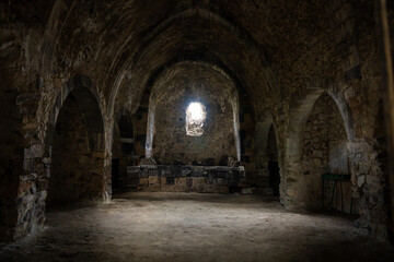 Naklejka premium Interior of an ancient Armenian church, featuring historic stone architecture, intricate carvings, and serene spiritual ambiance reflecting centuries of religious heritage.