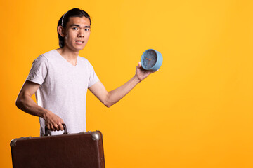 Man holds clock and briefcase with worried expression, reacting to fear of missing business...