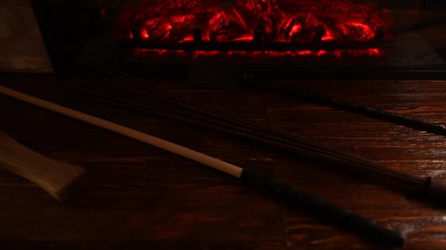 A set of BDSM whips by the fireplace. 