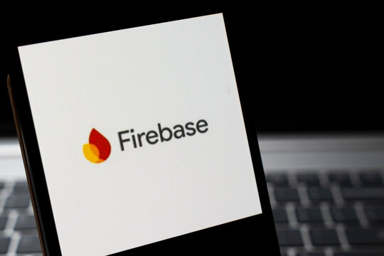 Warsaw, Poland - Feb 24, 2026: Close-up of a smartphone displaying the Firebase logo against a dark background, illustrating cloud services and app development solutions.