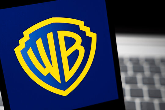 Warsaw, Poland - Feb 24, 2026: The Warner Bros logo displayed on a digital screen, symbolizing the film and entertainment industry, set against a dark background.