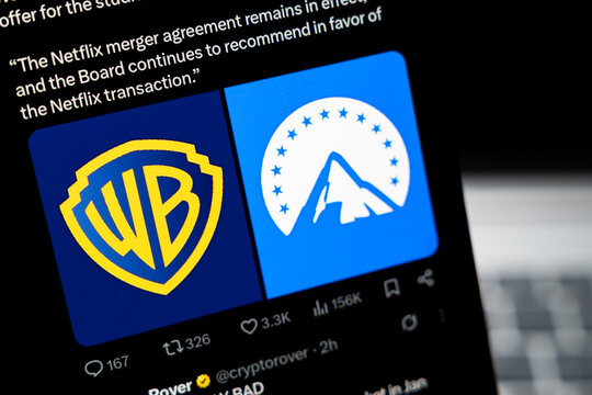 Warsaw, Poland - Feb 24, 2026: Logos of Warner Bros and Paramount Pictures displayed on a smartphone screen, highlighting a significant entertainment industry merger discussion.