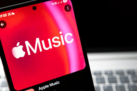 Warsaw, Poland - Feb 24, 2026: Close-up of an Apple Music app interface on a smartphone screen, showcasing vibrant colors and modern design, promoting digital streaming.